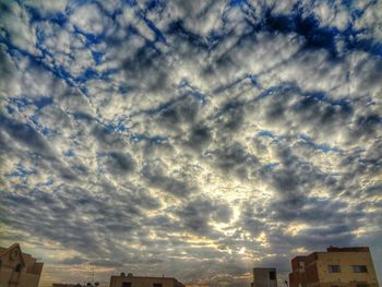 Low angle view of building against cloudy sky