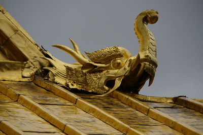 Low angle view of statue against sky