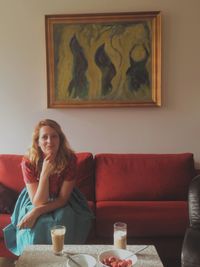 Woman sitting on sofa at home