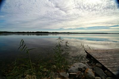 Scenic view of lake against cloudy sky