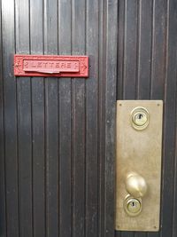 Close-up of text on wooden door