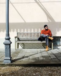 Full length of man sitting on bench