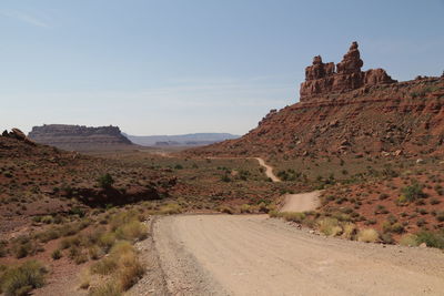 View of dirt road passing through mountain