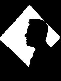 Close-up portrait of silhouette man against black background