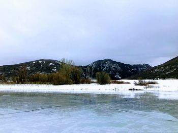 Scenic view of frozen lake against sky