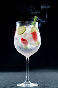 Close-up of drink on table against black background