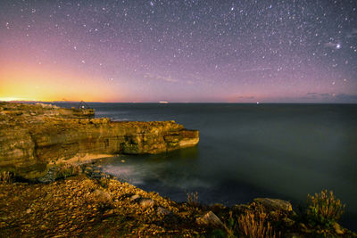 Scenic view of sea against sky at night