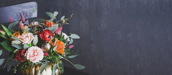 Close-up of flower vase against wall