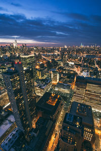 Aerial view of illuminated cityscape against sky