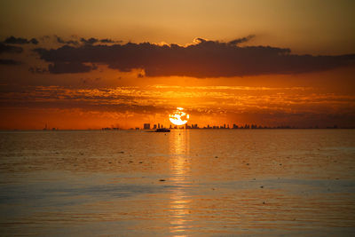 Scenic view of sea against orange sky