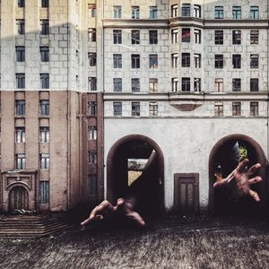 Man and woman against building