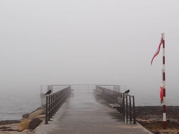 Pier over sea against sky