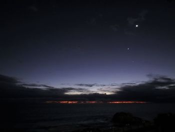 Scenic view of sea against sky at night