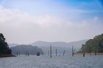 Scenic view of sea and mountains against sky