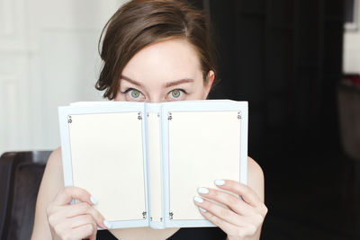 Midsection of woman reading book