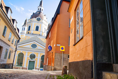 Low angle view of church buildings in city against sky