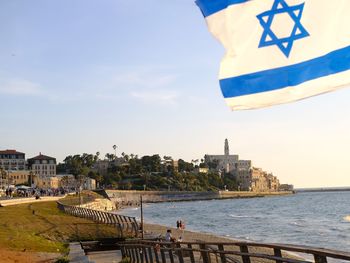 Scenic view of sea and buildings against sky