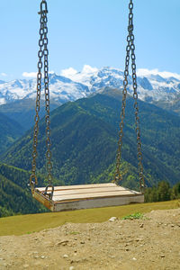 View of swing against mountain range