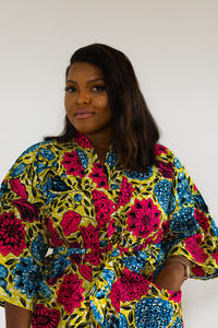 Young woman standing against white background