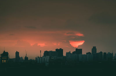 Buildings against sky in city during sunset