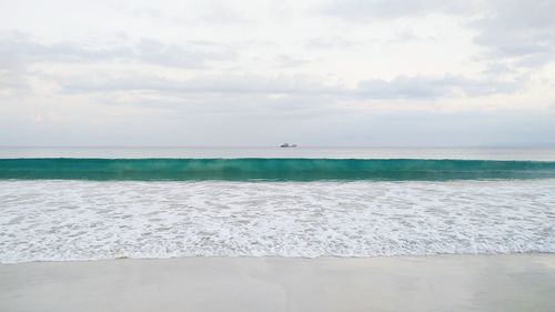 Scenic view of sea against cloudy sky