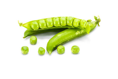 Close-up of green chili pepper against white background