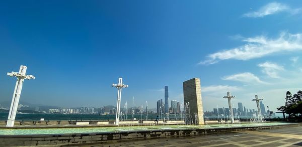 Modern buildings in city against blue sky