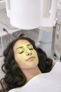 High angle view of patient having light therapy in medical clinic