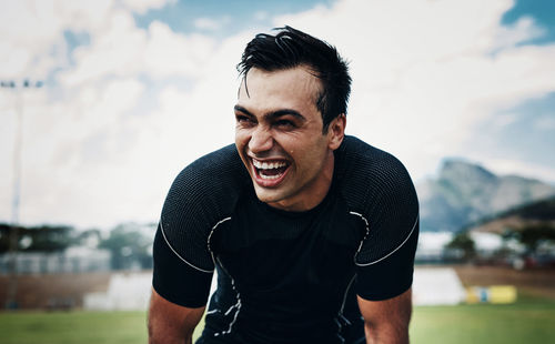 Cheerful sportsperson looking away