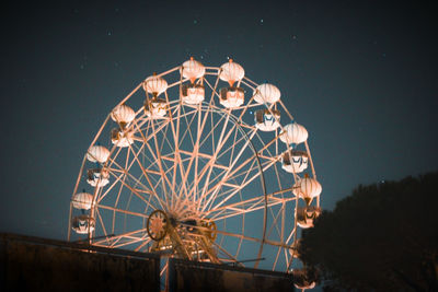 Low angle view of ferris wheel against sky at night