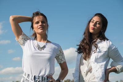 Portrait of happy women standing against sky