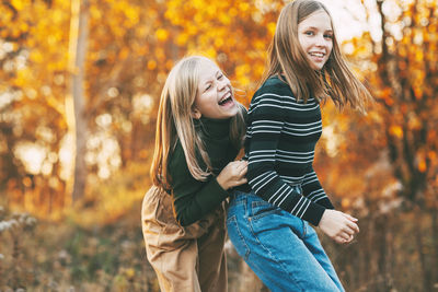 Portrait of a smiling young woman in autumn