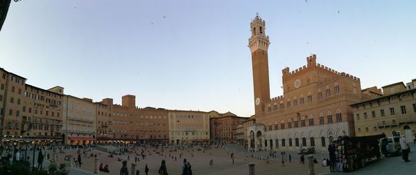 Group of people in historic building against sky