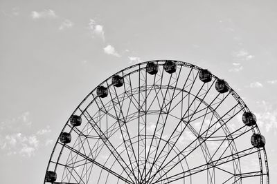 Low angle view of ferris wheel against sky