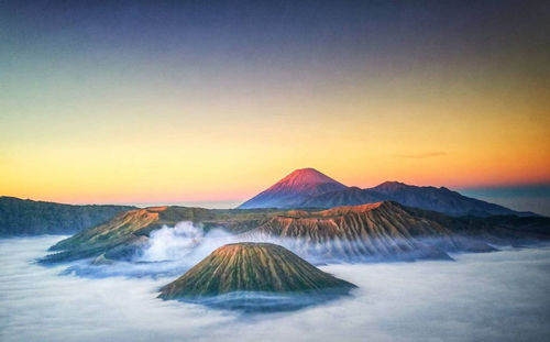 View of volcanic mountain against sky during sunset