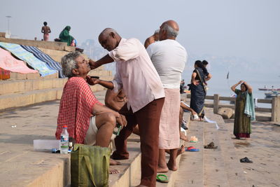 Rear view of people walking on road