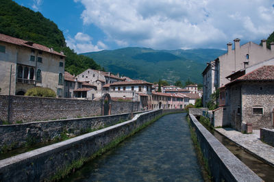 Town by buildings in city against sky