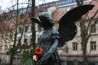 View of bird on statue against building