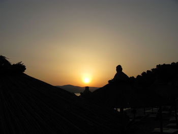 Silhouette mountains against clear sky during sunset