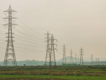 Scenic view of field and  high voltage power lines 
