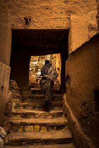 Rear view of woman on stairs