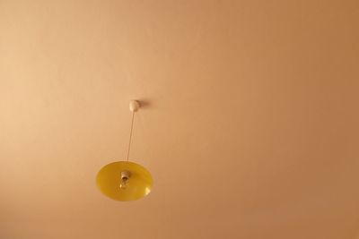 Low angle view of yellow balloons hanging on ceiling