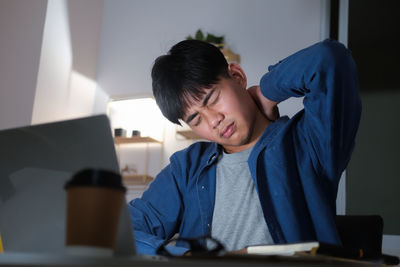 Boy sitting on table at home