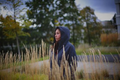 Thoughtful woman wearing warm clothing while standing at park