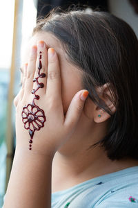 Close-up portrait of woman with hands