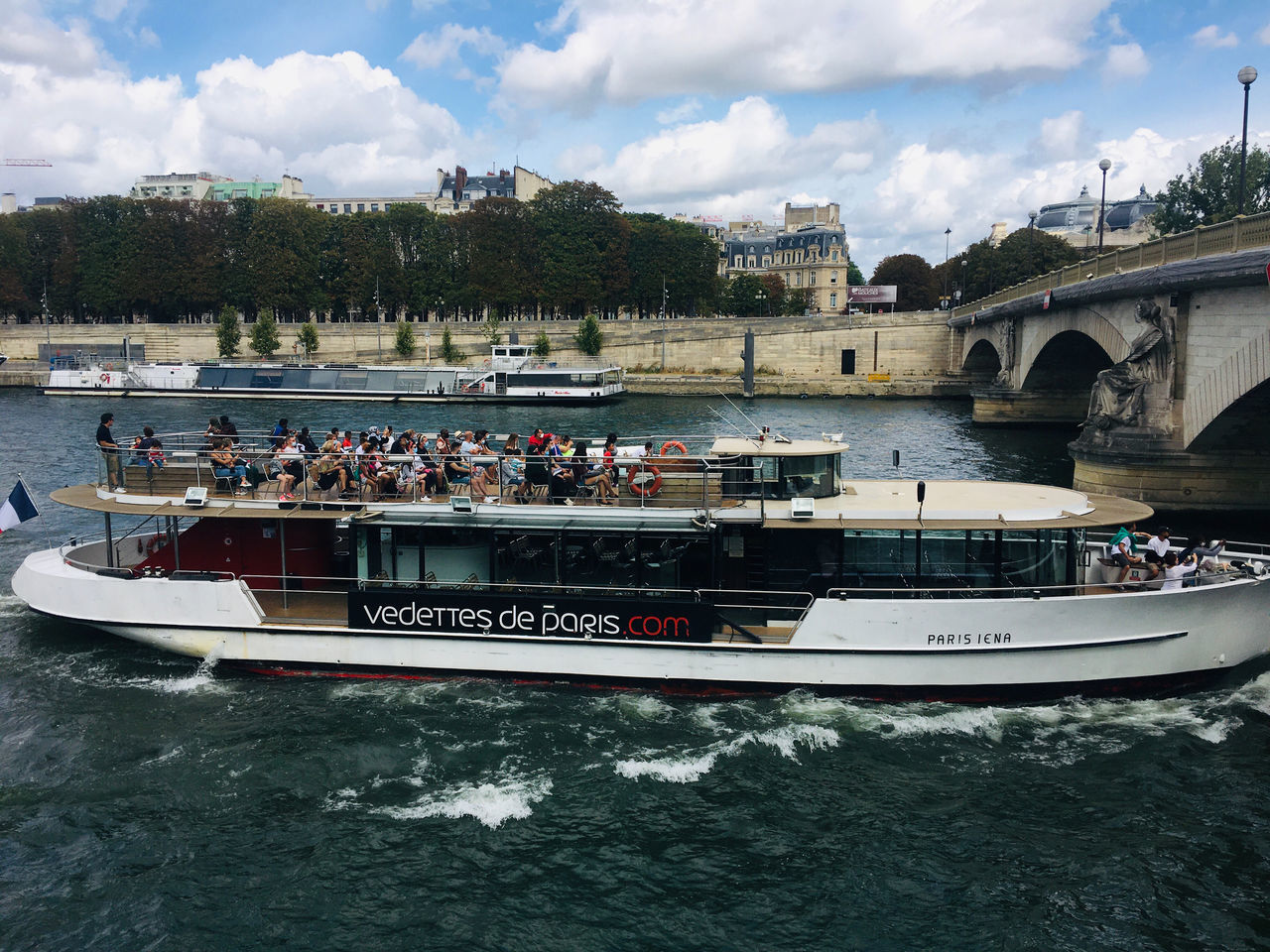 GROUP OF PEOPLE ON BOAT IN RIVER