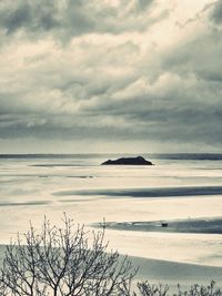 Scenic view of sea against cloudy sky