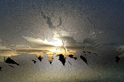 Group of people on snow covered land against sky