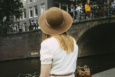 Woman in hat overlooking canal and city