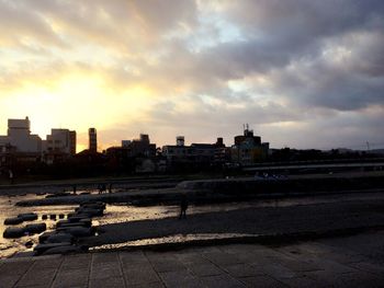 View of cityscape against cloudy sky